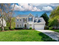 Charming two-story home with a manicured lawn and a two-car attached garage at 2815 Providence Spring Ln, Charlotte, NC 28270