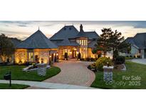 Stunning exterior view of luxurious home with stone accents, professional landscaping, and circular driveway at 325 Ivy Arbor Cir, Rock Hill, SC 29732