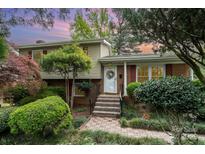 Charming split-level home with brick and siding, landscaped yard, and a welcoming front entrance with lovely steps at 5329 Glenbrier Dr, Charlotte, NC 28212