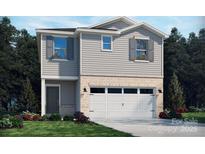 Charming two-story home featuring gray siding, brick accents, and an attached two-car garage at 811 Blue Canyon Dr, York, SC 29745