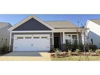 Charming home featuring a two-car garage and beautifully landscaped front yard at 1030 Mapletree Ln, Indian Trail, NC 28079