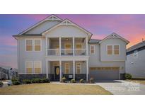 Inviting two-story home features a charming front porch and a two-car garage at 1103 Dryden Rd, Indian Trail, NC 28079