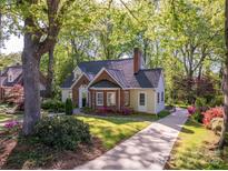 Inviting two-story home with brick and siding, a well-manicured lawn, and a driveway leading to a beautiful property at 1220 Oakwood Ave, Gastonia, NC 28052