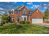 Beautiful two-story brick home with manicured lawn and attached two-car garage, enhancing curb appeal at 12531 Kane Alexander Dr, Huntersville, NC 28078