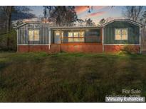 Charming exterior of a cozy home featuring a quaint porch and a brick foundation at 205 Jim Patterson Rd, Kings Mountain, NC 28086