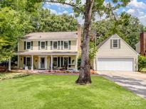 Charming two-story home with a well-maintained lawn and inviting front porch, perfect for relaxing outdoors at 2248 Lawton Bluff Rd, Charlotte, NC 28226