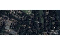 An aerial view of a residential area near a golf course, tennis courts, and waterfront at 4 Sunrise Point Rd, Clover, SC 29710