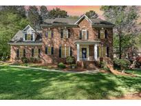 Beautiful brick home with a manicured lawn and stately entrance at 4511 Morning Dove Ct, Denver, NC 28037