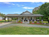 Charming home with a covered porch, carport and landscaped front yard at 481 Union Cemetery Sw Rd, Concord, NC 28027