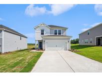 Charming two-story home with a modern facade, large garage, and well-maintained lawn at 5016 Poplin Vly, Cherryville, NC 28021