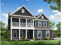 Charming two-story home with a welcoming front porch and beautifully landscaped front yard at 5100 Verona Rd # 96, Charlotte, NC 28213