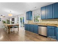 Bright eat-in kitchen with granite countertops, stainless steel appliances, and sliding glass door to backyard at 512 Red Oak Ct, Fort Mill, SC 29708
