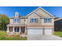 Charming two-story home features a brick-accented front, three-car garage, and covered porch at 8067 Kennesaw Dr, Gastonia, NC 28056