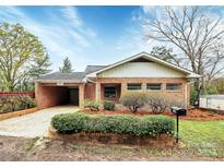 Charming brick home with a well-manicured front yard and an attached carport at 105 Deaver St, Chester, SC 29706