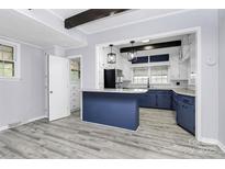 Charming kitchen with stainless steel appliances, blue cabinets, and a breakfast bar at 105 Deaver St, Chester, SC 29706
