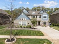 Beautiful two-story home with a manicured lawn, stone accents, and a welcoming front entrance at 10904 Kilkenny Dr, Matthews, NC 28105