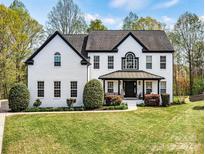 Charming two-story brick home with manicured lawn and inviting curb appeal at 1840 Sapona Ct, Denver, NC 28037