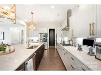 Bright kitchen featuring quartz countertops, stainless steel appliances and statement gold pendant lighting at 2332 Paddlers Cove Dr, Lake Wylie, SC 29710