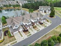 Beautiful aerial view of townhomes, landscaped grounds, and a serene pond with a fountain feature at 44455 Oriole Dr # 100, Indian Land, SC 29707