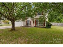 Traditional two-story home with mature trees and well-kept lawn at 5519 Burning Ridge Dr, Monroe, NC 28110