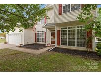 Charming two-story home with white siding, red shutters, and an attached two-car garage at 5519 Burning Ridge Dr, Monroe, NC 28110