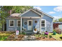 Charming bungalow featuring a covered front porch, landscaped yard, and inviting curb appeal at 608 Forney Ave, Lincolnton, NC 28092