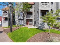 Attractive townhome exterior with cedar shake siding and lush lawn at 9025 J M Keynes Dr # 69, Charlotte, NC 28262