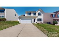 Charming two-story home featuring a two-car garage and well-maintained front lawn at 10848 Tailwater St, Davidson, NC 28036