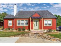 Charming red home featuring a stone walkway, inviting entrance, and well-maintained landscaping at 1110 S New Hope Rd, Gastonia, NC 28054