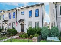 Charming two-story home featuring neat landscaping and a welcoming front entrance with an awning at 119 Capital Ave # E, Mooresville, NC 28117