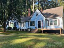 Charming single Gathering home featuring a well-maintained lawn and classic architectural details at 200 Cleveland Ave, Shelby, NC 28150