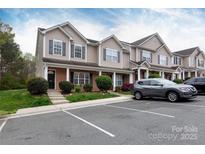 Inviting townhome exterior with manicured landscaping and a convenient parking area at 3138 Golden Dale Ln, Charlotte, NC 28262