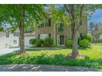 Charming two-story brick home featuring a well-manicured lawn and a two-car garage at 3712 Autumn Gold Ct, Charlotte, NC 28278