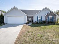 Charming single-story home with a well-manicured lawn, a two-car garage, and stone accents at 4002 Shadow Pines Cir, Indian Trail, NC 28079
