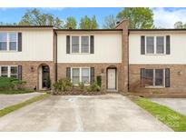 Charming brick townhome featuring well-maintained landscaping and inviting curb appeal at 485 Camrose Ne Cir, Concord, NC 28025