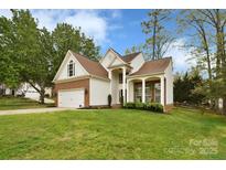 Charming two-story home featuring a manicured lawn and attached two car garage at 6301 Baberton Ct, Charlotte, NC 28269