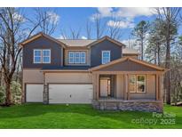 New construction home featuring a two-car garage, covered porch, and professionally landscaped lawn at 7117 Cobblefield Ln, Denver, NC 28037
