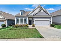 Charming single-Gathering home with a well-manicured lawn, classic curb appeal, and a two-car garage at 7850 Fountaingrass Ln, Sherrills Ford, NC 28673