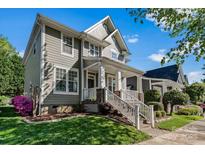 Charming home featuring a well-manicured lawn and welcoming front porch with stylish white railings at 8311 Camberly Rd, Huntersville, NC 28078