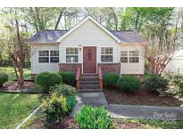 Charming one-story home featuring updated landscaping and inviting front porch at 11100 Pine Grove Ave, Mint Hill, NC 28227