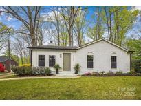 Charming white brick home with a well-manicured lawn and lush landscaping at 1162 Westover Cir, Rock Hill, SC 29732