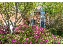 Charming two-story brick home featuring a manicured lawn and vibrant azalea bushes at 19113 Southport Dr, Cornelius, NC 28031