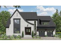 Charming two-story home featuring a stylish white brick facade, a modern black roof, and a well-manicured front yard at 19134 Newburg Hill Rd, Davidson, NC 28036
