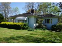 Charming single-story home with mature landscaping and a well-maintained lawn at 311 33Rd Street Se Dr, Hickory, NC 28602
