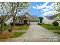 Charming home with stone accents, manicured lawn, and a spacious two-car garage at 8621 Sequoia Grove Ln, Charlotte, NC 28214
