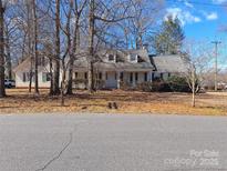 Charming one-story home featuring a covered front porch and mature trees at 927 Elizabeth Rd, Shelby, NC 28150
