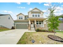 Charming two-story home with a covered front porch, two-car garage, and well-maintained landscaping at 10161 Castlebrooke Dr, Concord, NC 28027