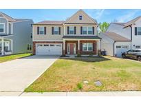 Charming two-story home with a two-car garage, manicured lawn, and covered front porch at 162 Aspire Cir, Wingate, NC 28174