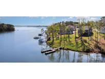 Stunning waterfront property with private dock and serene lake views on a sunny day, perfect for boating and relaxation at 19650 Harbor Watch Ct, Lancaster, SC 29720