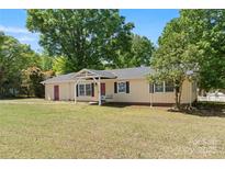 Inviting single story home featuring a classic porch swing and a well-manicured front yard at 2115 Fowler Secrest Rd, Monroe, NC 28110